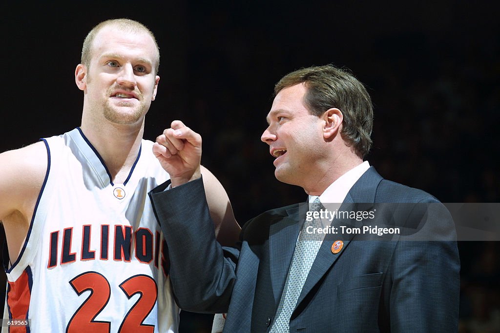 Lucas Johnson of Illinois is playfully punched by Head Coach Bill