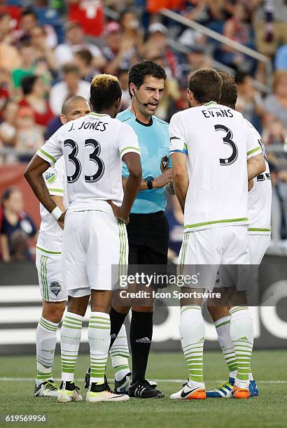 Seattle Sounders FC defender Brad Evans argues a penalty kick call with referee Fotis Bazakos. The New England Revolution defeated the Seattle...