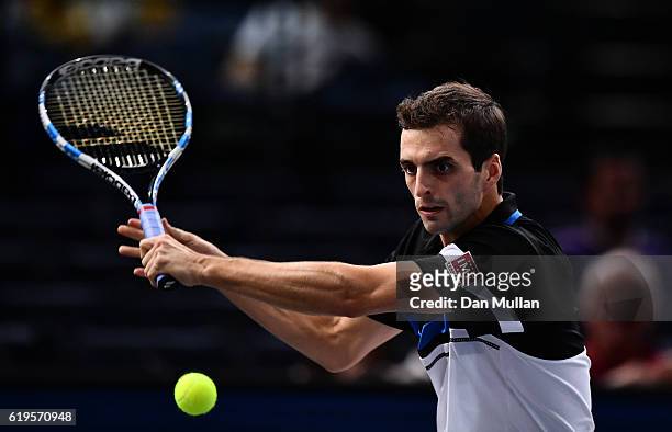 Albert Ramos-Vinolas of Spain plays a backhand against Stephane Robert of France during the Mens Singles first round match on day one of the BNP...