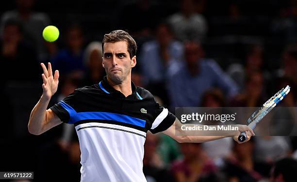 Albert Ramos-Vinolas of Spain plays a forehand against Stephane Robert of France during the Mens Singles first round match on day one of the BNP...