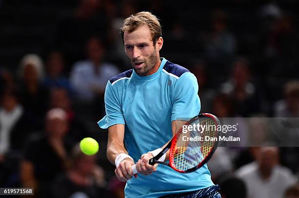 Stephane Robert of France plays a backhand against Albert Ramos-Vinolas of Spain during the Mens Singles first round match on day one of the BNP...