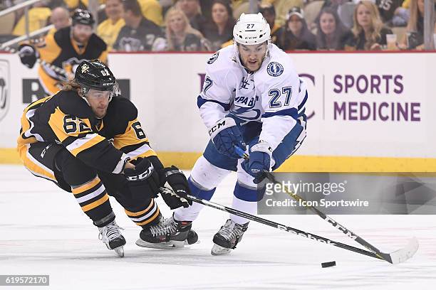 Tampa Bay Lightning left wing Jonathan Drouin and Pittsburgh Penguins left wing Carl Hagelin go for the puck during the first period of Game Seven in...