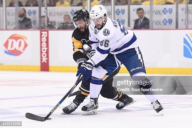 Tampa Bay Lightning right wing Nikita Kucherov and Pittsburgh Penguins defenseman Kris Letang battle for the puck during the first period of Game...