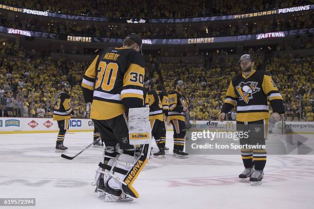Pittsburgh Penguins goalie Matt Murray and Pittsburgh Penguins right wing Bryan Rust skates to center ice after a 2-1 against the Tampa Bay Lightning...