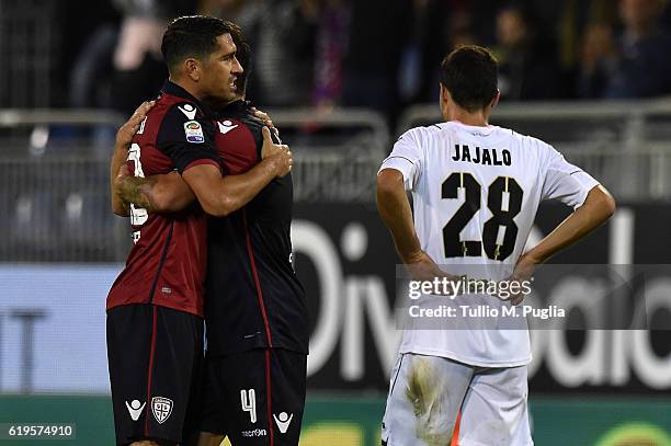 Mato Jajalo of Palermo looks on as Marco Borriello and Daniele Dessena of Cagliari celebrate after winning the Serie A match between Cagliari Calcio...