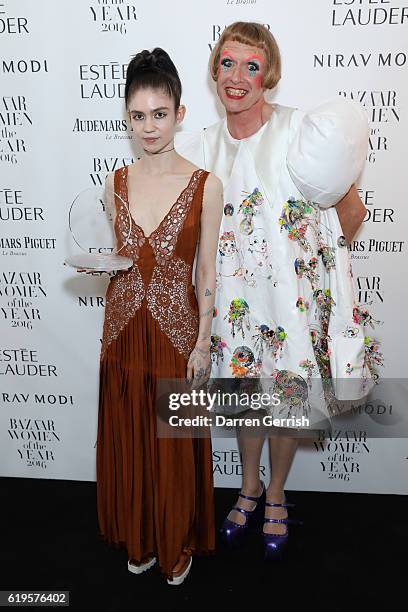 Claire Elise Boucher AKA Grimes and Grayson Perry attend Audemars Piguet Sponsor Of The Harper's Bazarre Women Of The Year Awards 2016 at Claridges...