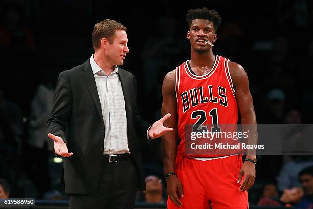 Head coach Fred Hoiberg of the Chicago Bulls talks with Jimmy Butler against the Brooklyn Nets during the first half at Barclays Center on October...