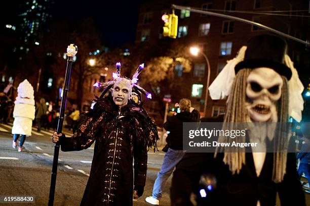 Revelers make their way along Sixth Avenue during the 43rd annual Village Halloween Parade, October 31, 2016 in New York City. Thousands of people...