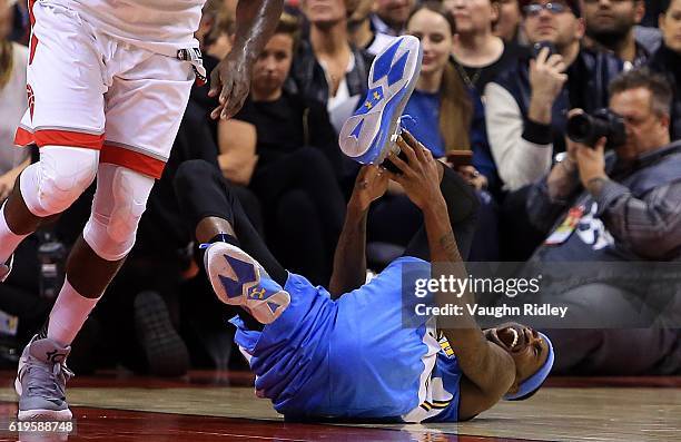 Will Barton of the Denver Nuggets injures his ankle during the second half of an NBA game against the Toronto Raptors at Air Canada Centre on October...