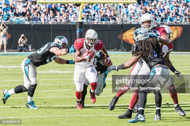 Arizona Cardinals running back David Johnson carries the ball as Carolina Panthers Linebacker Luke Kuechly and Carolina Panthers Cornerback Robert...