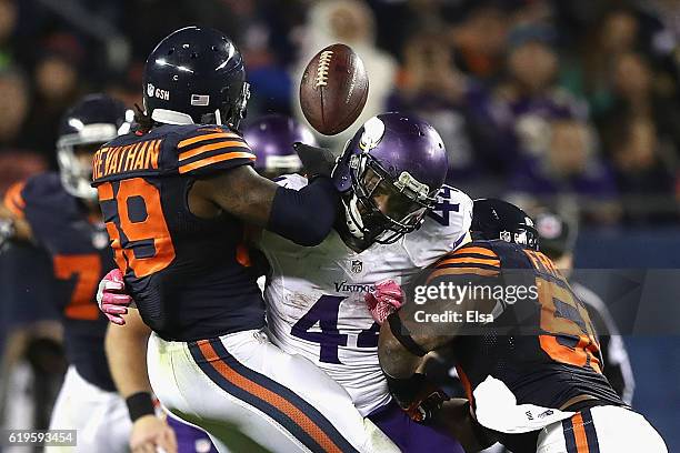 Danny Trevathan and Jerrell Freeman of the Chicago Bears break up a pass intended for Matt Asiata of the Minnesota Vikings during the fourth quarter...