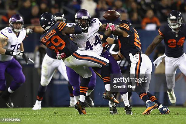 Danny Trevathan and Jerrell Freeman of the Chicago Bears break up a pass intended for Matt Asiata of the Minnesota Vikings during the fourth quarter...