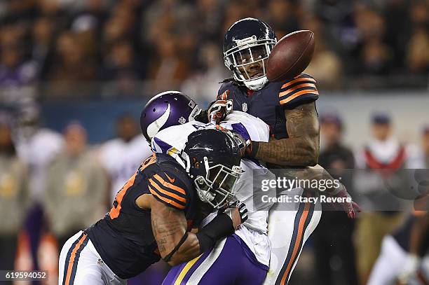 Danny Trevathan and Jerrell Freeman of the Chicago Bears break up a pass intended for Matt Asiata of the Minnesota Vikings during the fourth quarter...