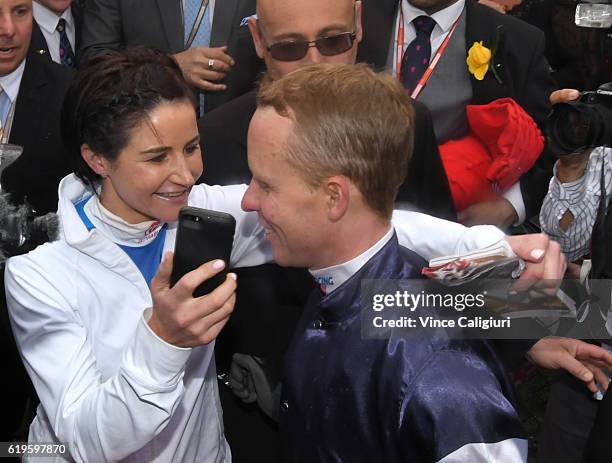 Michelle Payne hands the phone with his wife Cathy Payne speaking after Kerrin McEvoy rode Almandin to win Race 7, the Emirates Melbourne Cup on...