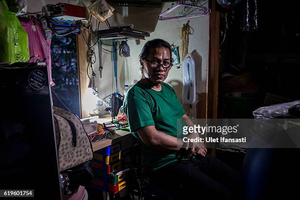 Transvestite Yanti , poses for photograph inside her house, Yanti has joined the group for 22 years in a traditional dance opera group called Ludruk...