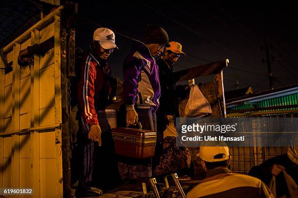Transvestite Winarti , prepares to step down from a truck after arrives at the performing location on October 29, 2016 in Surabaya, Indonesia....