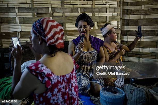 Transvestites apply make-up in the backstage before performing a traditional dance opera known as Ludruk on October 29, 2016 in Surabaya, Indonesia....