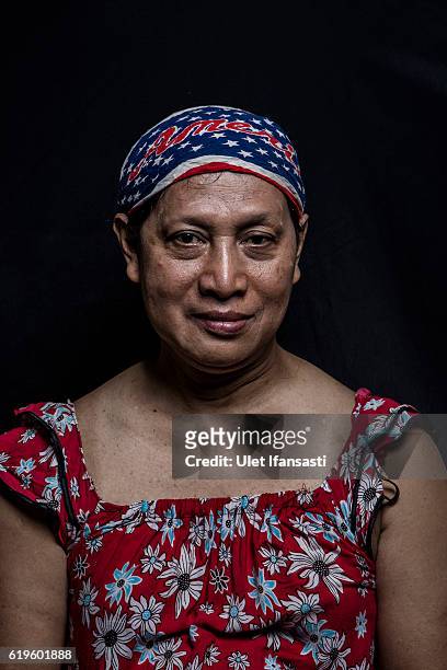 Transvestite Neni Wijaya , poses to photograph before performing a traditional dance opera known as Ludruk on October 29, 2016 in Surabaya,...