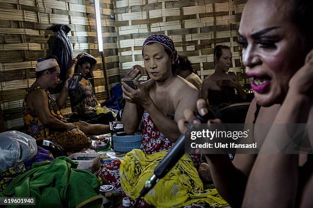 Transvestites apply make-up in the backstage before performing a traditional dance opera known as Ludruk on October 29, 2016 in Surabaya, Indonesia....