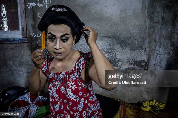 Transvestite Neni Wijaya , prepares backstage before performing a traditional dance opera known as Ludruk on October 30, 2016 in Surabaya, Indonesia....