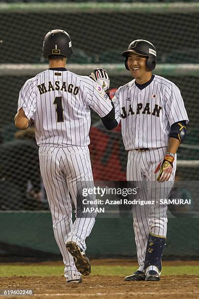 Yusuke Masago of Japan shake hands with teammate Takumi Miyoshi during the WBSC U-23 Baseball World Cup Group B game between Austria and Japan at...