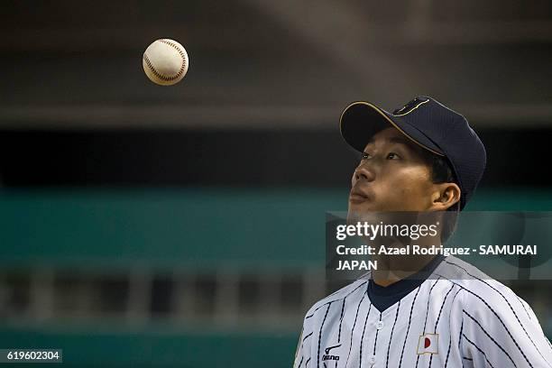 Ryota Yoshimochi of Japan observes the ball during the WBSC U-23 Baseball World Cup Group B game between Austria and Japan at Estadio de Beisbol...