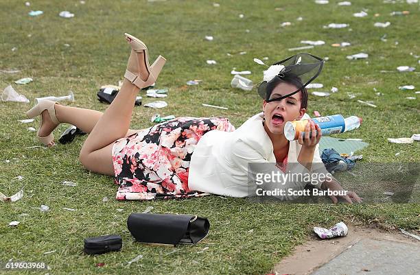 Racegoers falls over following 2016 Melbourne Cup Day at Flemington Racecourse on November 1, 2016 in Melbourne, Australia.