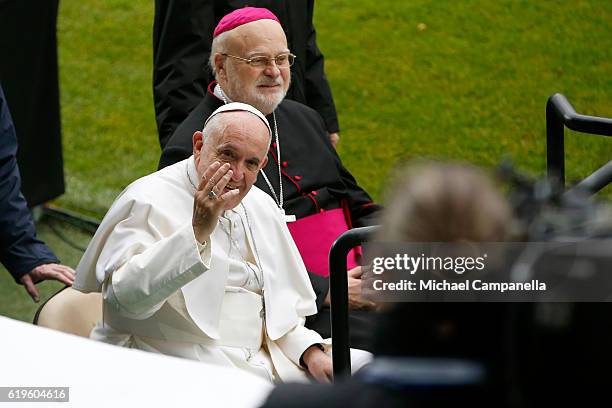 Pope Francis and Sweden's Catholic bishop Anders Arborelius greet participants as he arrives for the Holy Mass at the Swedbank Stadion on November 1,...