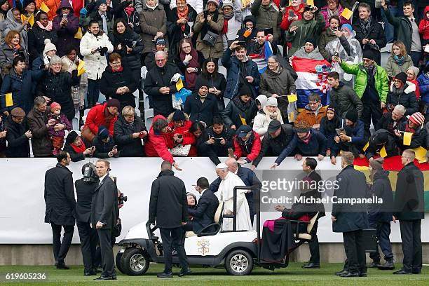 Pope Francis greets participants as he arrives for the Holy Mass at the Swedbank Stadion on November 1, 2016 in Malmo, Sweden. The Pope is on 2 days...
