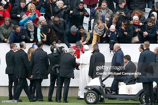 Pope Francis greets participants as he arrives for the Holy Mass at the Swedbank Stadion on November 1, 2016 in Malmo, Sweden. The Pope is on 2 days...