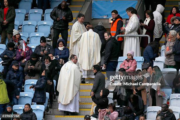 Priests walk into the crowd to administer Communion during the Holy Mass with Pope Francis at the Swedbank Stadion on November 1, 2016 in Malmo,...