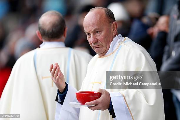 Priests walk into the crowd to administer Communion during the Holy Mass with Pope Francis at the Swedbank Stadion on November 1, 2016 in Malmo,...