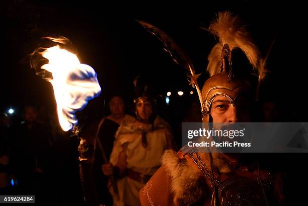 Revellers hold torches as they parade near the ancient Celtiberian settlement of Numantia, famous for its role in the Celtiberian War, in Soria,...