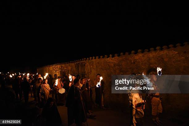 Revellers hold torches as they parade near the ancient Celtiberian settlement of Numantia, famous for its role in the Celtiberian War, in Soria,...