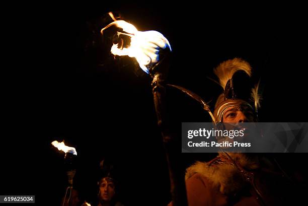 Revellers hold torches as they parade near the ancient Celtiberian settlement of Numantia, famous for its role in the Celtiberian War, in Soria,...