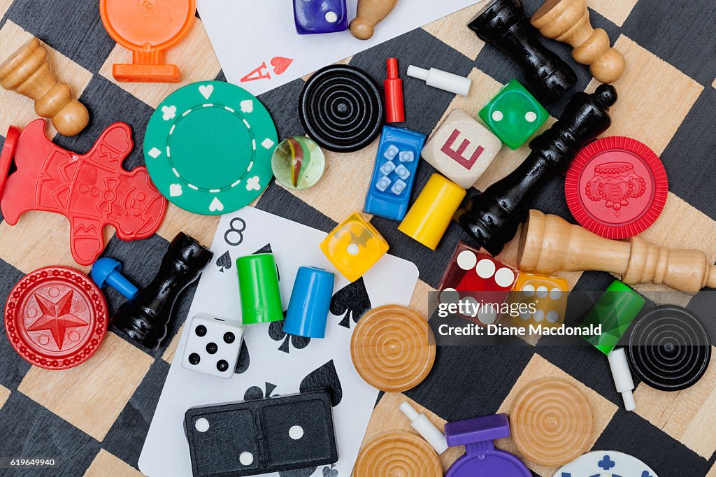 Miscellaneous board game pieces on a chess board