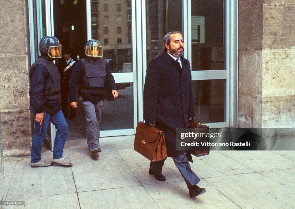 Italian Judge Italian judge Giovanni Falcone is escorted by police out of the Court ...