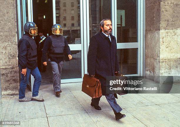 Italian judge Giovanni Falcone is escorted by police out of the Court of Palermo, Italy, on May 16, 1985. Giovanni Falcone was killed by the Mafia in...
