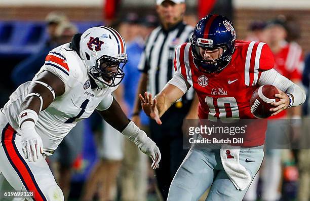 Quarterback Chad Kelly of the Mississippi Rebels tries to get past defensive tackle Montravius Adams of the Auburn Tigers as he scrambles for yardage...