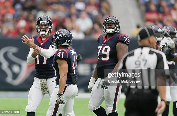 Brock Osweiler of the Houston Texans motions to the officials after he felt DeAndre Hopkins was held on his route in the fourth quarter against the...