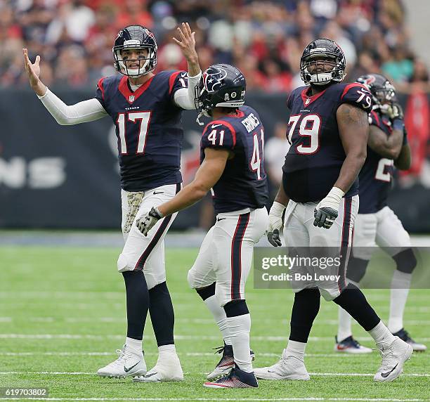 Brock Osweiler of the Houston Texans motions to the officials after he felt DeAndre Hopkins was held on his route in the fourth quarter against the...