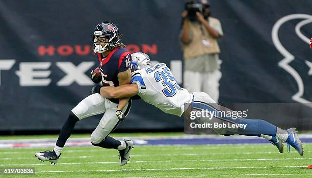 Will Fuller of the Houston Texans is tackled by Miles Killebrew of the Detroit Lions at NRG Stadium on October 30, 2016 in Houston, Texas.