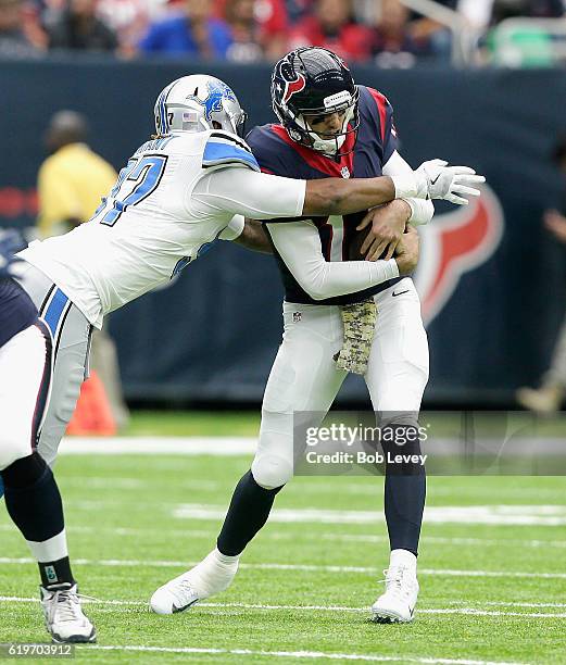 Brock Osweiler of the Houston Texans flinches as he is sacked by Armonty Bryant of the Detroit Lions at NRG Stadium on October 30, 2016 in Houston,...