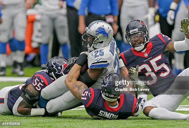 Theo Roddick of the Detroit Lions is tackled by John Simon of the Houston Texans, Eddie Pleasant and Benardrick McKinney at NRG Stadium on October...