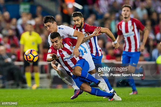 Angel Correa of Club Atletico de Madrid fights for the ball with Federico Ricca Rostagnol of Malaga CF during their La Liga match between Club...