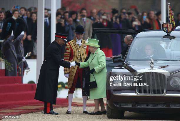 Britain's Queen Elizabeth II is greeted as she arrives for the ceremonial welcome with Britain's Prince Philip, Duke of Edinburgh at the start of the...