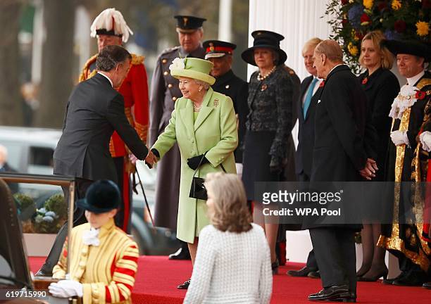 Queen Elizabeth II greets Colombia's President Juan Manuel Santos as Prince Philip looks on at a ceremonial welcome for Colombia's President Juan...