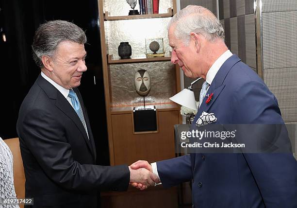 Prince Charles, Prince of Wales greets President of Colombia Juan Manuel Santos and his wife María Clemencia Rodríguez Múnera in their suite at the...