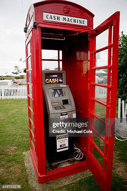 Red Telephone Box housing an ATM cash machine on lawn beside the Assembly Area at Goodwood on September 10, 2016 in Chichester, England.