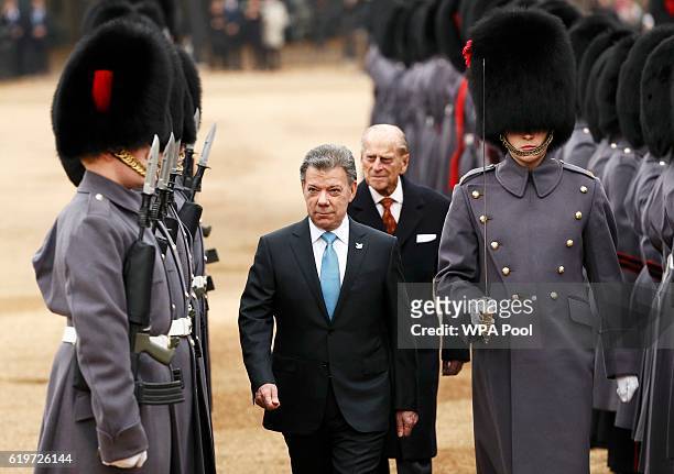 Colombia's President Juan Manuel Santos inspects an honour guard with Prince Philip, Duke of Edinburgh during his ceremonial welcome at Horse Guards...